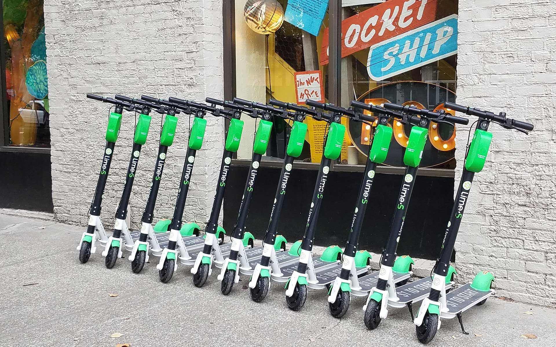 A Row of Lime Scooters Parked Downtown