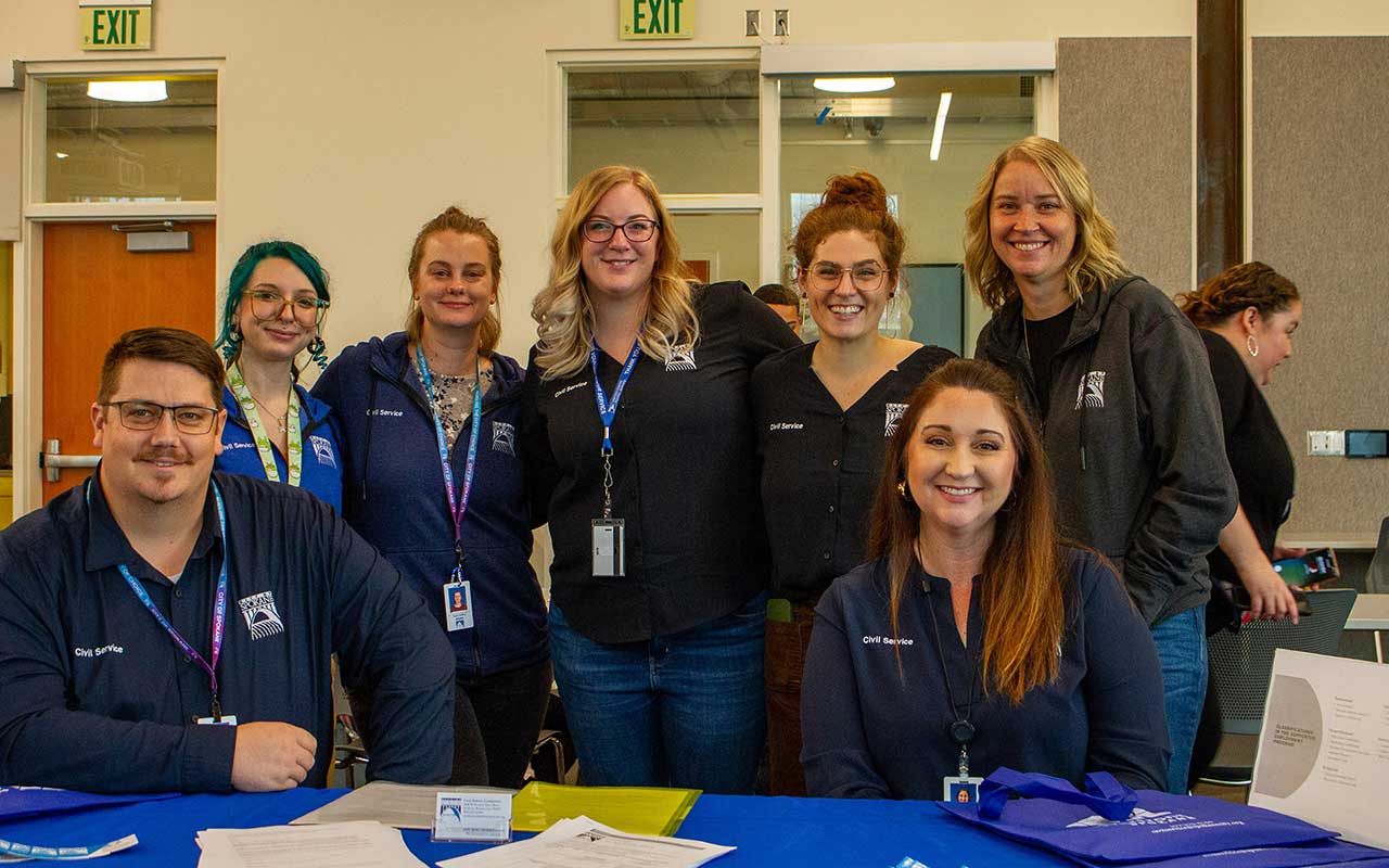 The City of Spokane Civil Service team behind a booth at a career fair