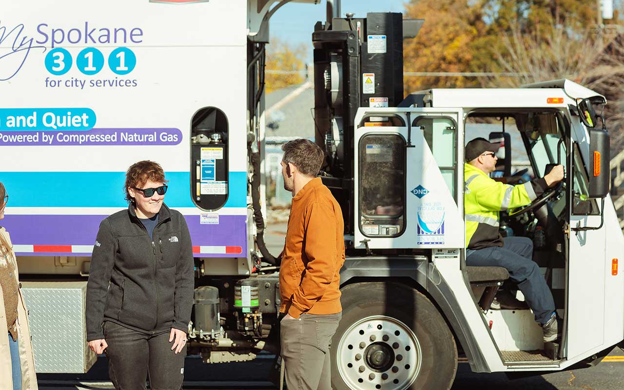 Group of people in front of City of Spokane garbage truck