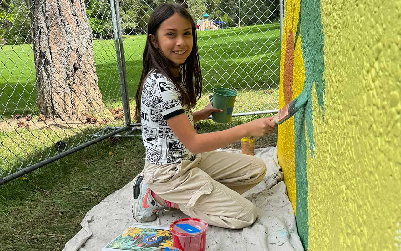 Kid Painting the Lincoln Park Shelter Mural