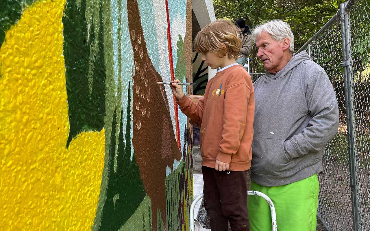 Two people painting the Lincoln Park Shelter Mural